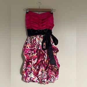 Strapless pink satin ruffle dress with black bow